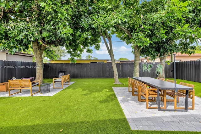 view of yard with an outdoor living space and a patio area