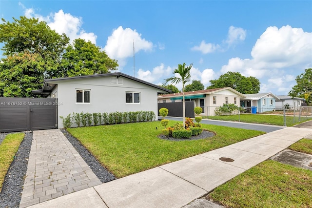 single story home featuring a front lawn