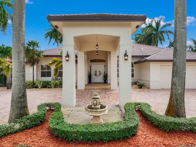 doorway to property with a garage