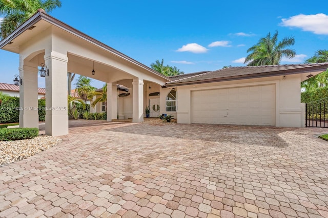 3601 SW 129th Ave, Miami, FL 33175 - view of front facade with stucco siding, decorative driveway, and a garage