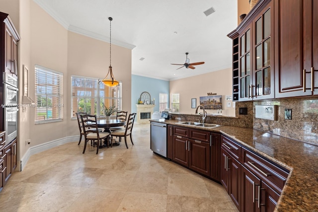 kitchen with ornamental molding, sink, hanging light fixtures, and stainless steel appliances