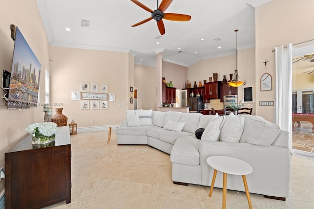 tiled living room with ornamental molding, high vaulted ceiling, and ceiling fan