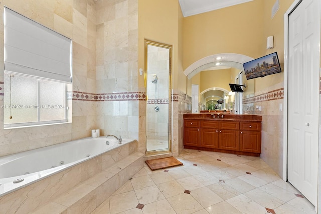 bathroom with tile walls, vanity, plus walk in shower, and ornamental molding