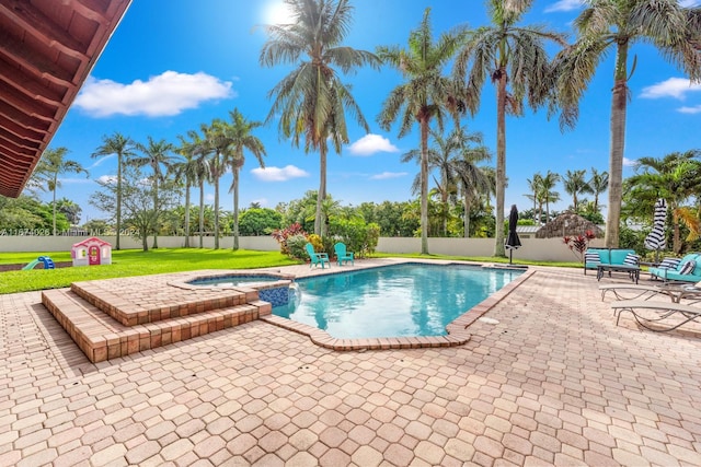 view of pool featuring an in ground hot tub, a patio area, and a lawn