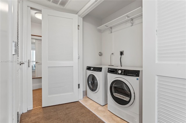 4401 Collins Ave Unit 915, Miami Beach, FL 33140 - laundry area featuring washer and clothes dryer and light colored carpet