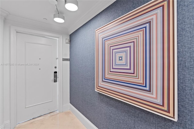 entryway featuring ornamental molding and light tile patterned flooring