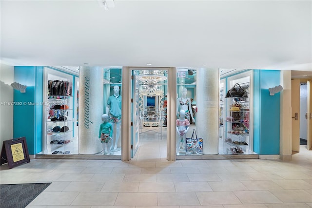 exercise room with light tile patterned floors and floor to ceiling windows