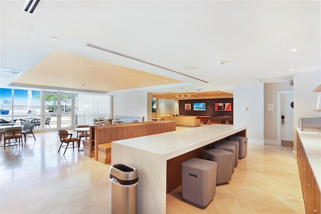 4401 Collins Ave Unit 915, Miami Beach, FL 33140 - kitchen with open floor plan, a wall of windows, light countertops, a large island, and recessed lighting