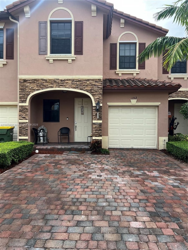 152 SE 37th Ter Unit 152, Homestead, FL 33033 - mediterranean / spanish house with a garage, stucco siding, decorative driveway, and stone siding