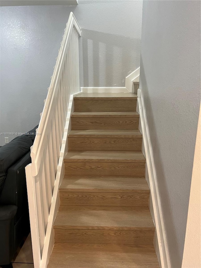 staircase featuring hardwood / wood-style flooring