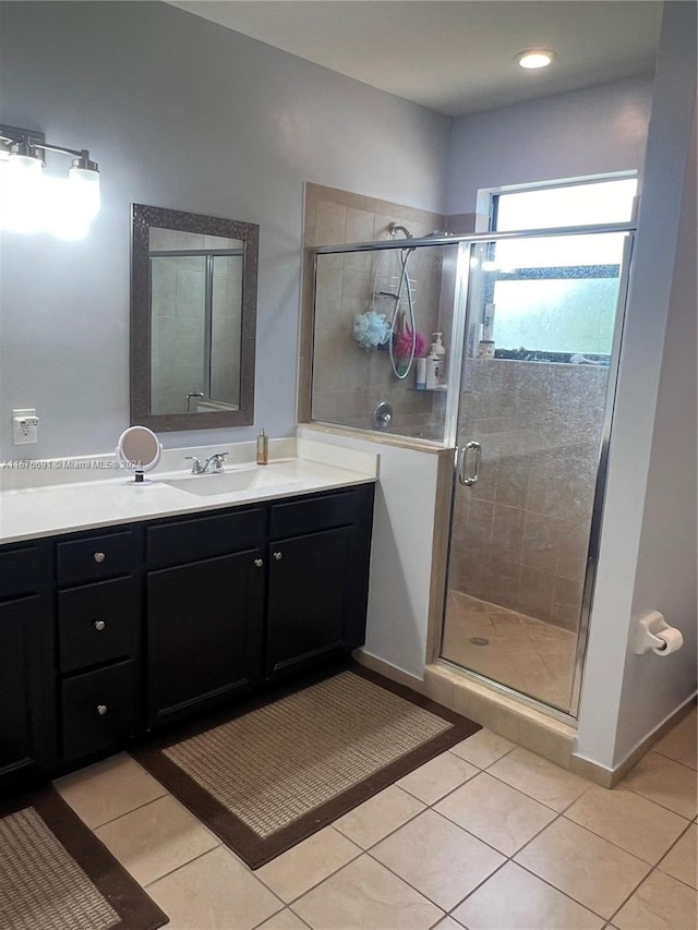 bathroom with vanity, tile patterned flooring, and an enclosed shower