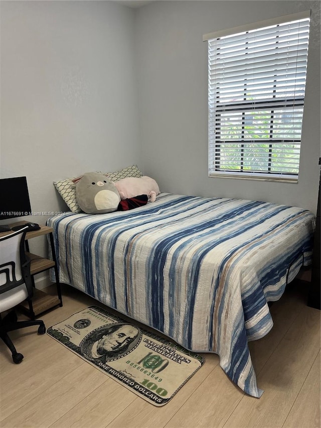 bedroom with hardwood / wood-style floors