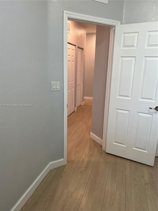 corridor featuring light hardwood / wood-style floors