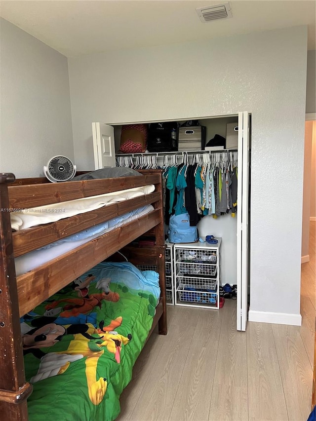 bedroom with a closet and light hardwood / wood-style floors