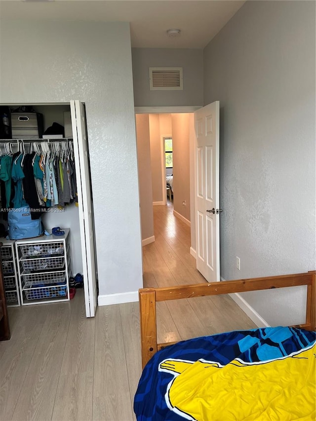 bedroom with a closet and hardwood / wood-style flooring