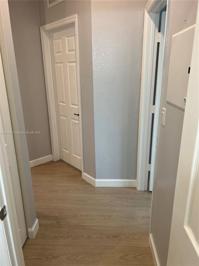 152 SE 37th Ter Unit 152, Homestead, FL 33033 - hallway featuring a textured wall, baseboards, and wood finished floors