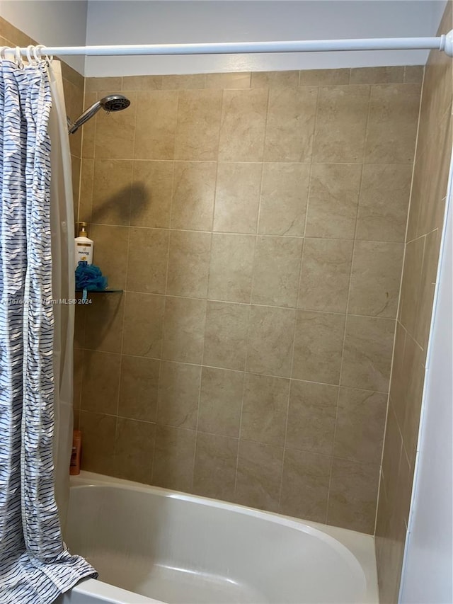 bathroom with shower / bathtub combination with curtain