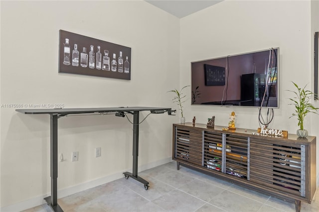 bar featuring tile patterned floors and baseboards