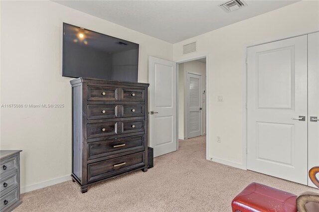 interior space featuring baseboards, visible vents, and light carpet