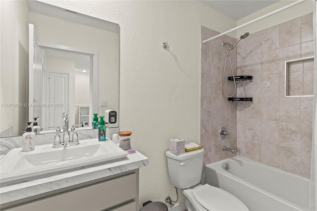 full bathroom with shower / bathtub combination, toilet, vanity, and a textured wall