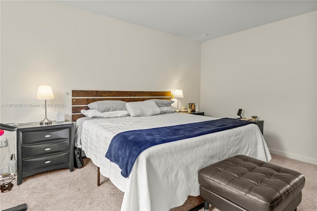 carpeted bedroom featuring baseboards