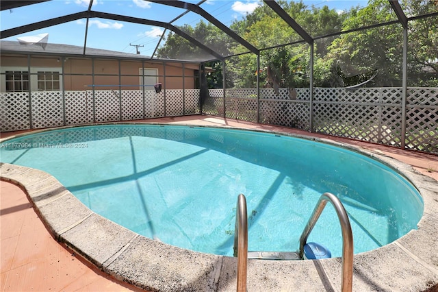 view of pool featuring a lanai