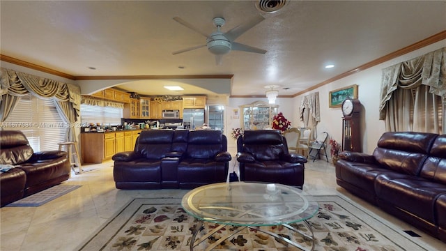 living room featuring crown molding, a textured ceiling, and ceiling fan