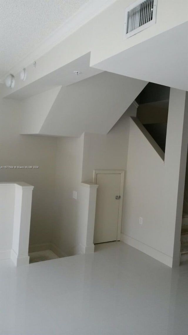 interior space with concrete floors and a textured ceiling