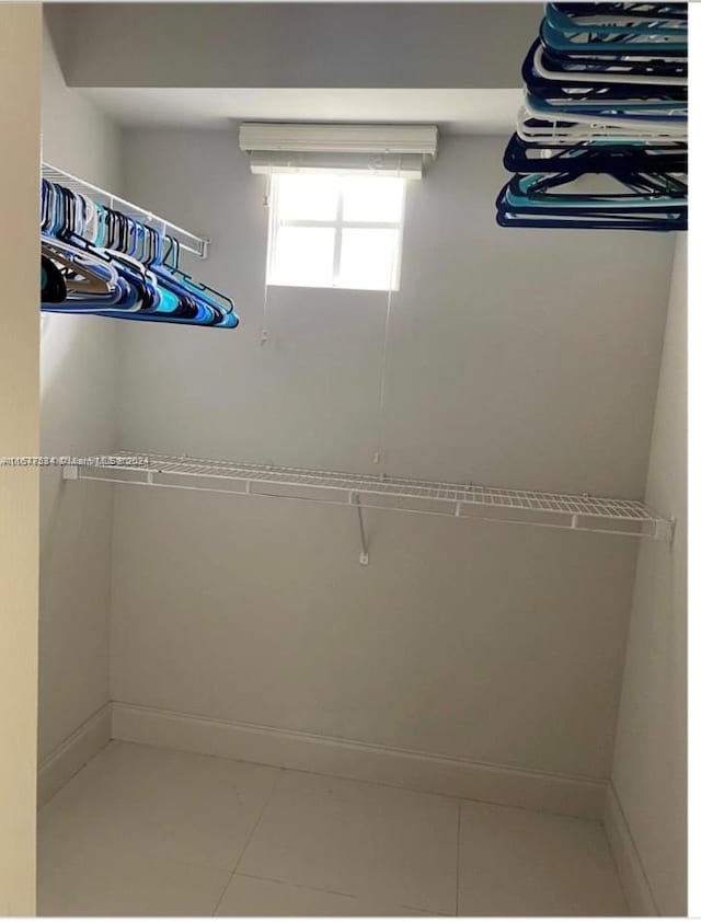 walk in closet featuring light tile patterned floors