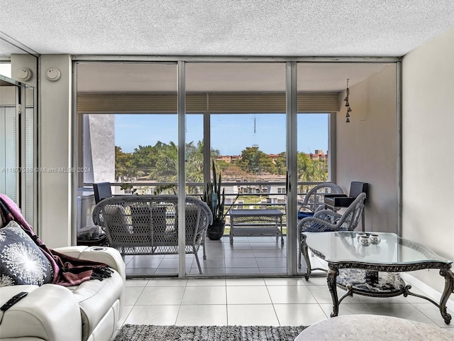 interior space with a textured ceiling, light tile patterned floors, and plenty of natural light