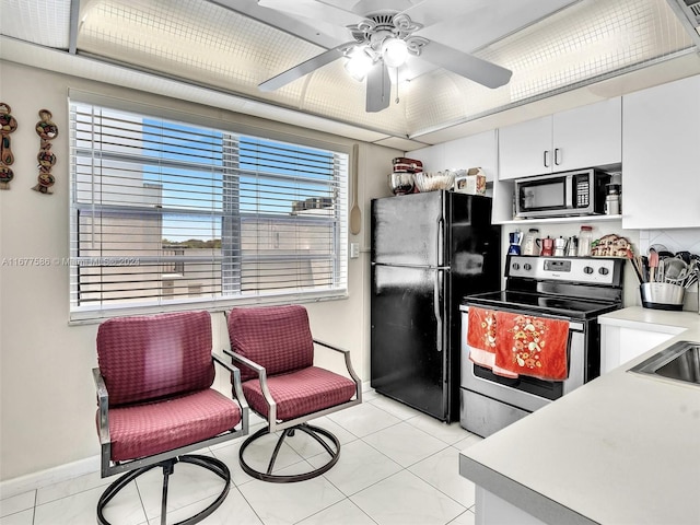 kitchen featuring white cabinets, ceiling fan, stainless steel appliances, and light tile patterned floors