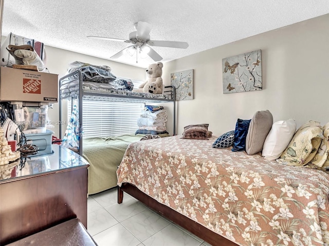 bedroom with ceiling fan and a textured ceiling