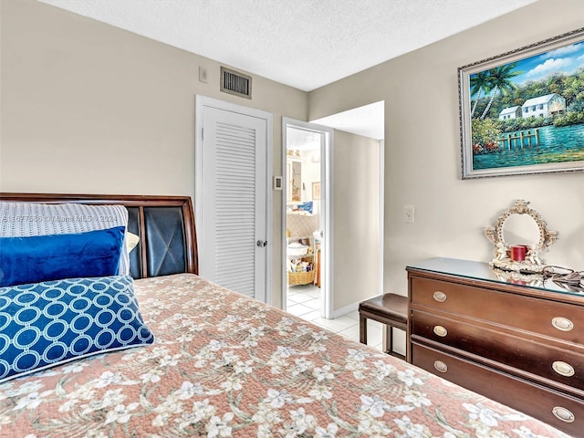 tiled bedroom featuring a textured ceiling