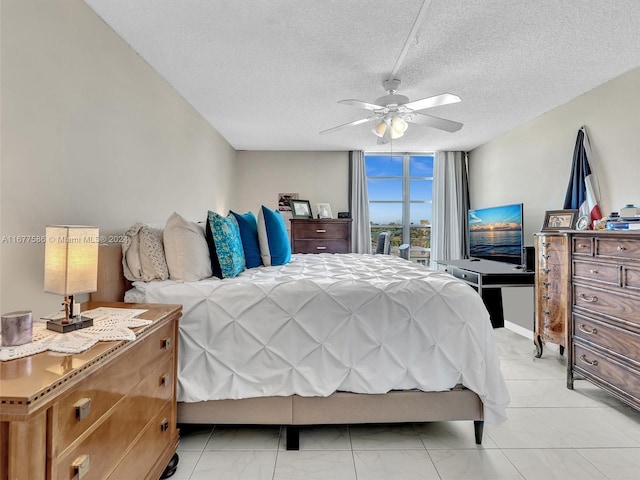 bedroom with ceiling fan, a textured ceiling, and floor to ceiling windows