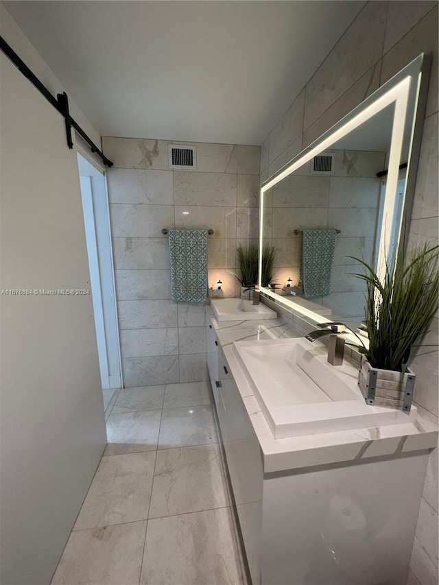 bathroom with vanity and tile walls