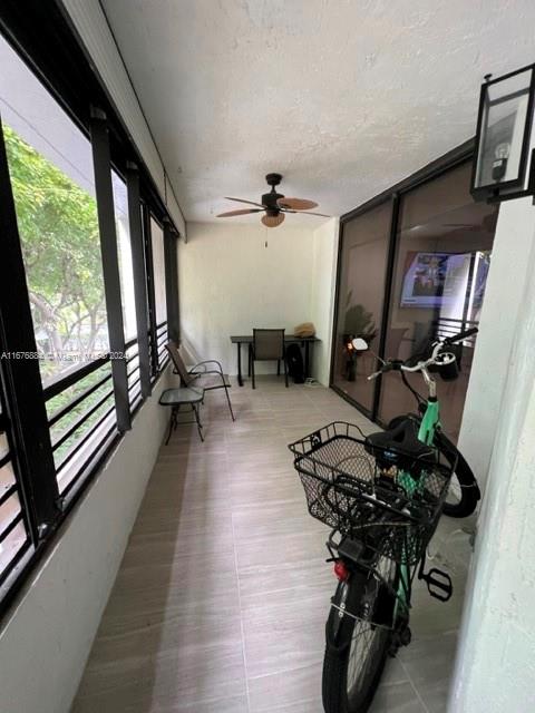 sunroom / solarium with ceiling fan