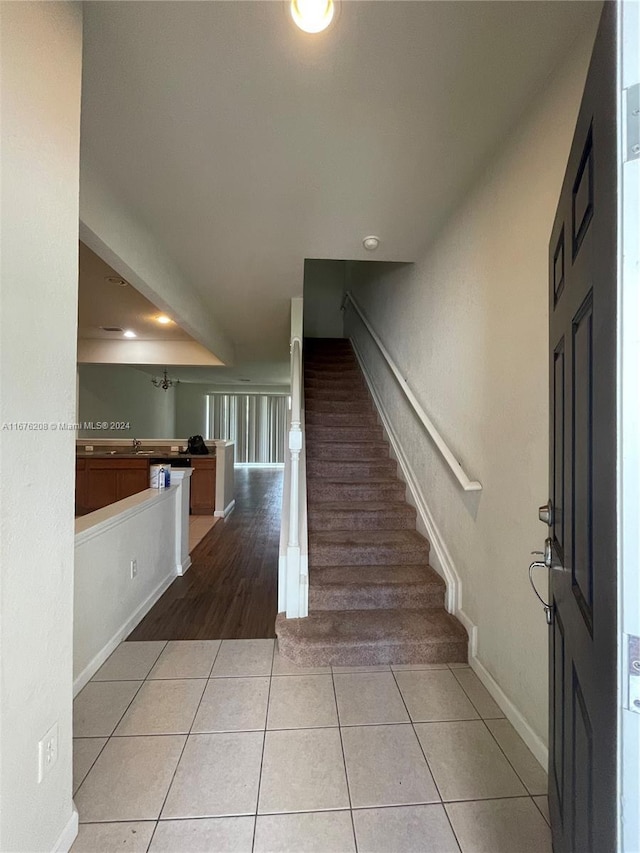foyer featuring stairway, baseboards, recessed lighting, and light tile patterned floors