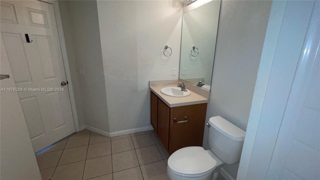 bathroom featuring toilet, vanity, and tile patterned floors