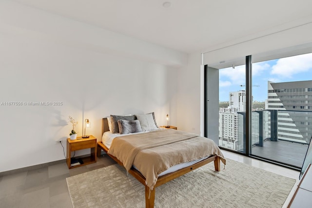 88 SW 7th St Unit 1710, Miami, FL 33130 - bedroom featuring access to exterior, expansive windows, baseboards, and a view of city