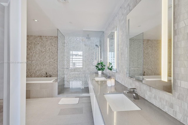 88 SW 7th St Unit 1710, Miami, FL 33130 - bathroom featuring tile walls, tiled shower, double vanity, and a garden tub