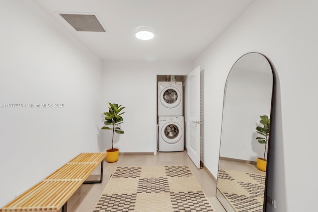 88 SW 7th St Unit 1710, Miami, FL 33130 - washroom featuring stacked washer / dryer and light flooring