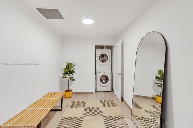 88 SW 7th St Unit 1710, Miami, FL 33130 - laundry room featuring stacked washer and clothes dryer and light flooring