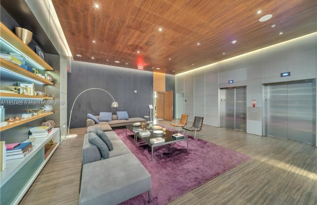 living room featuring elevator, a high ceiling, and wooden ceiling