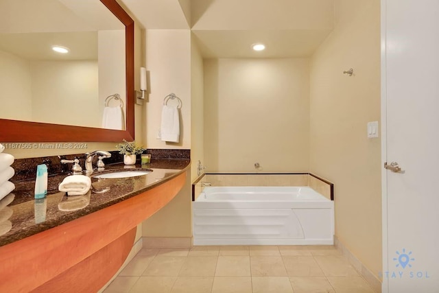 bathroom featuring a bathing tub, sink, and tile patterned floors