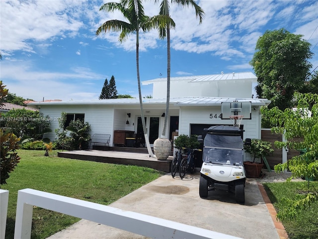 rear view of property with a yard