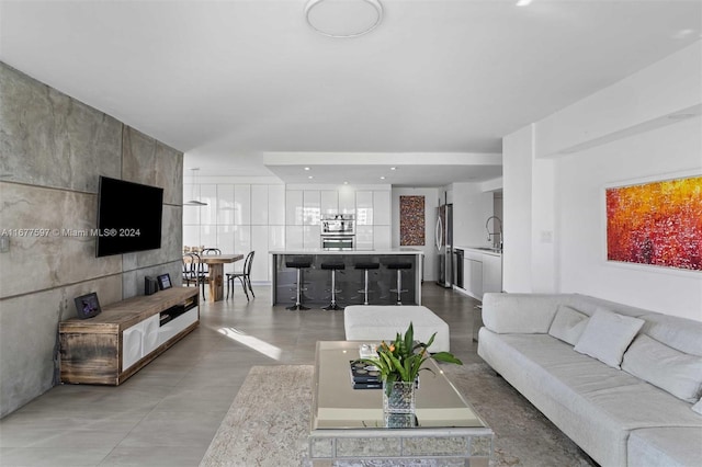 living room featuring sink and concrete floors