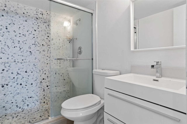 bathroom with vanity, toilet, and an enclosed shower