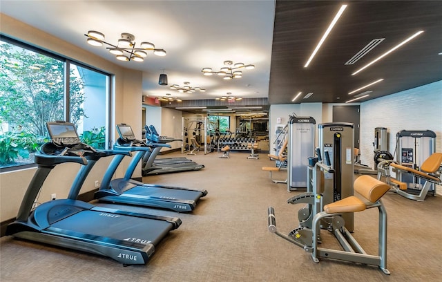 gym with a notable chandelier