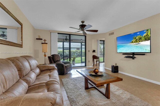 tiled living room with ceiling fan