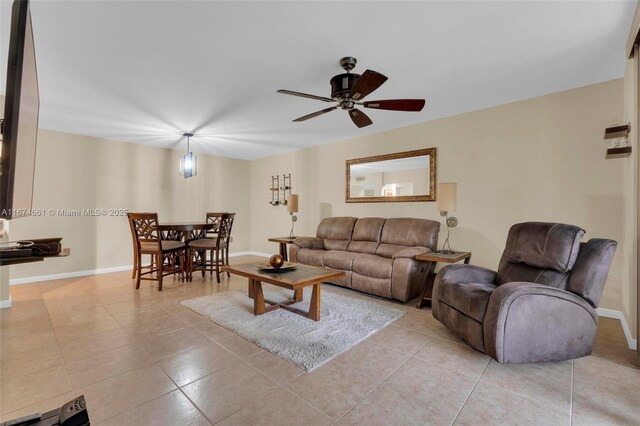 tiled living room with ceiling fan